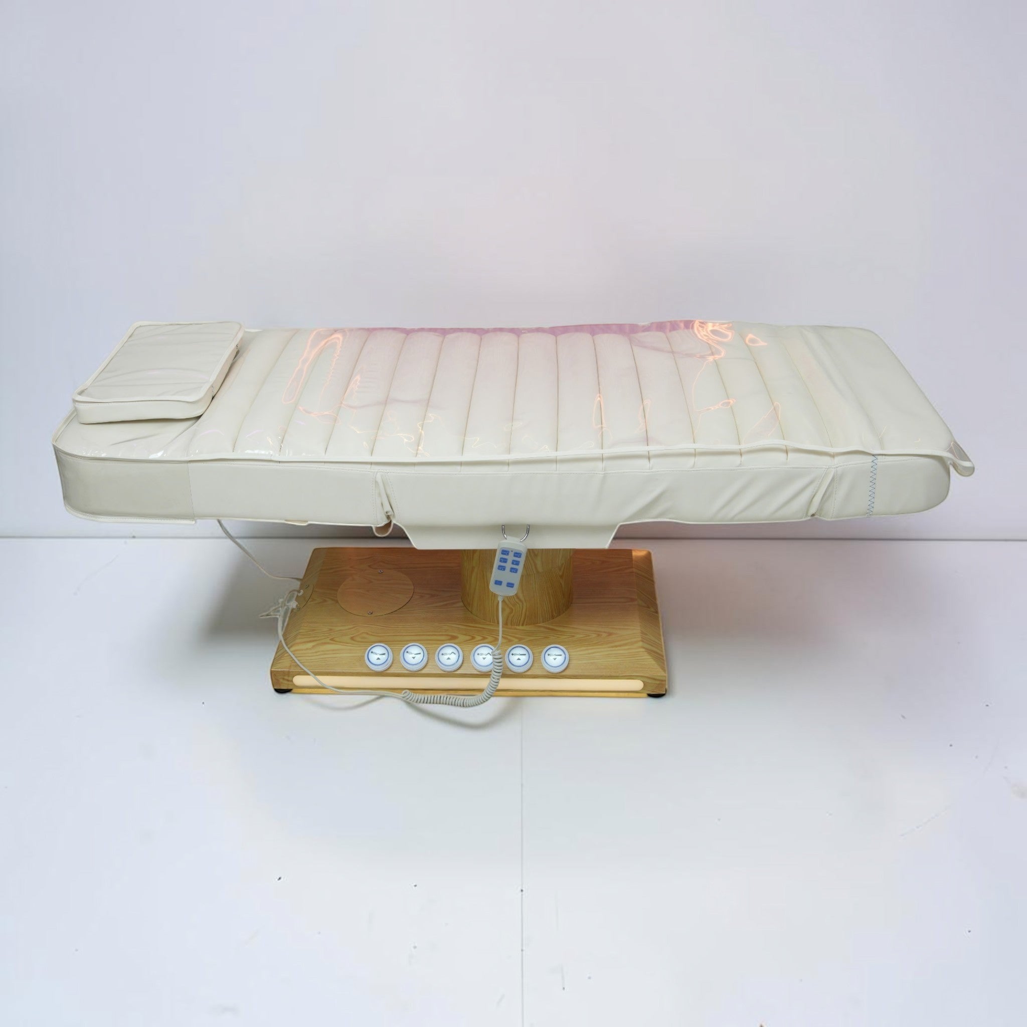 MK BEAUTY BED luxury electric treatment bed in white PU leather with a wooden base and handheld remote control.