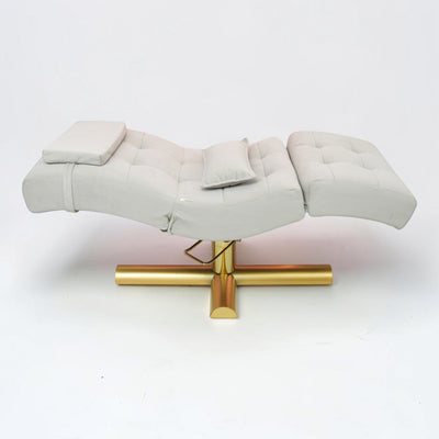 MK BEAUTY BED All in One Curved Bed in light grey with a gold hydraulic base, featuring an ergonomic design.
