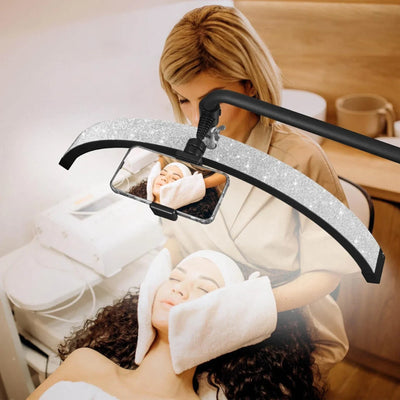 MK BEAUTY BED diamond half moon LED light providing shadow-free illumination for a facial treatment in a salon
