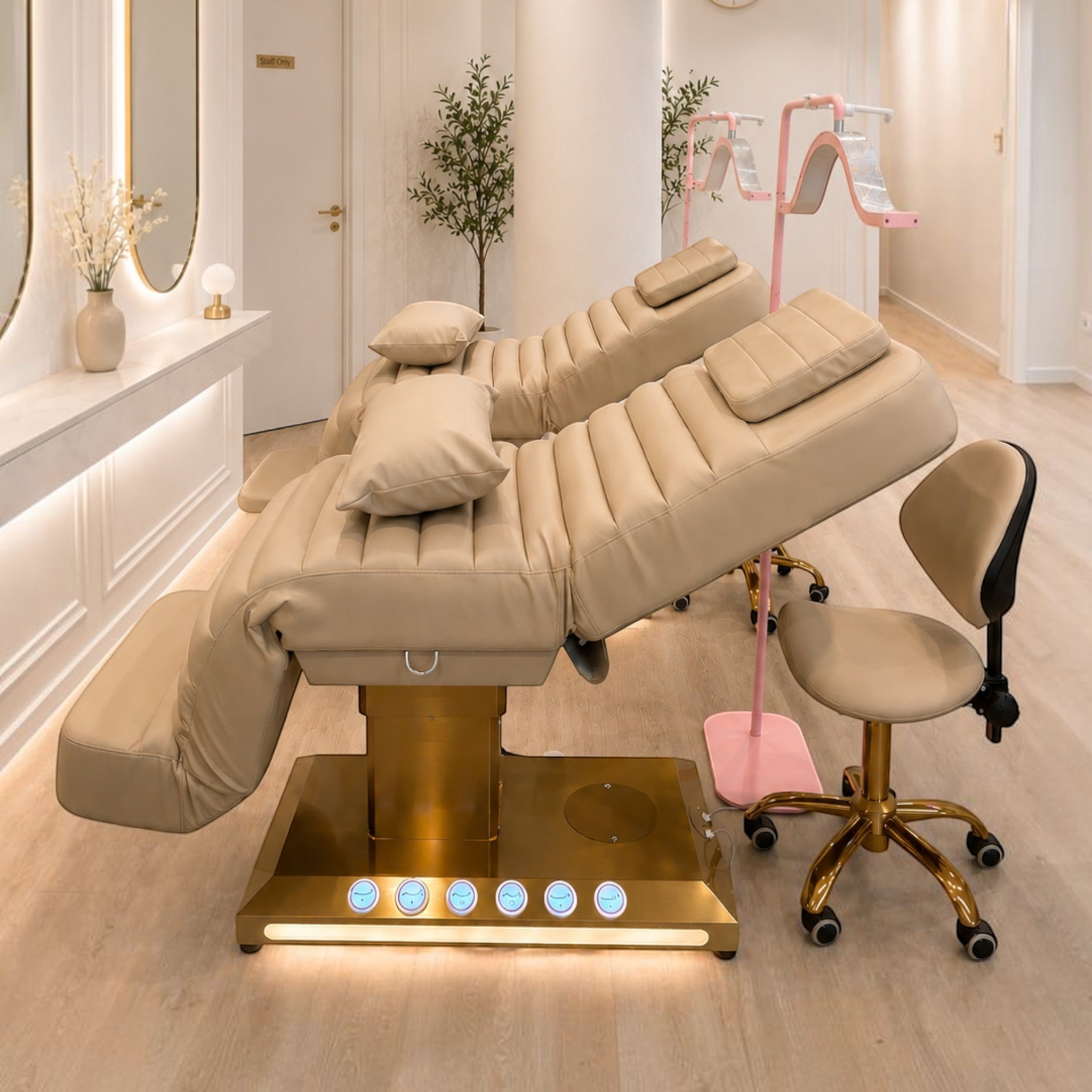 MK BEAUTY BED luxury electric treatment bed in beige PU leather with gold base and matching salon stool in a studio
