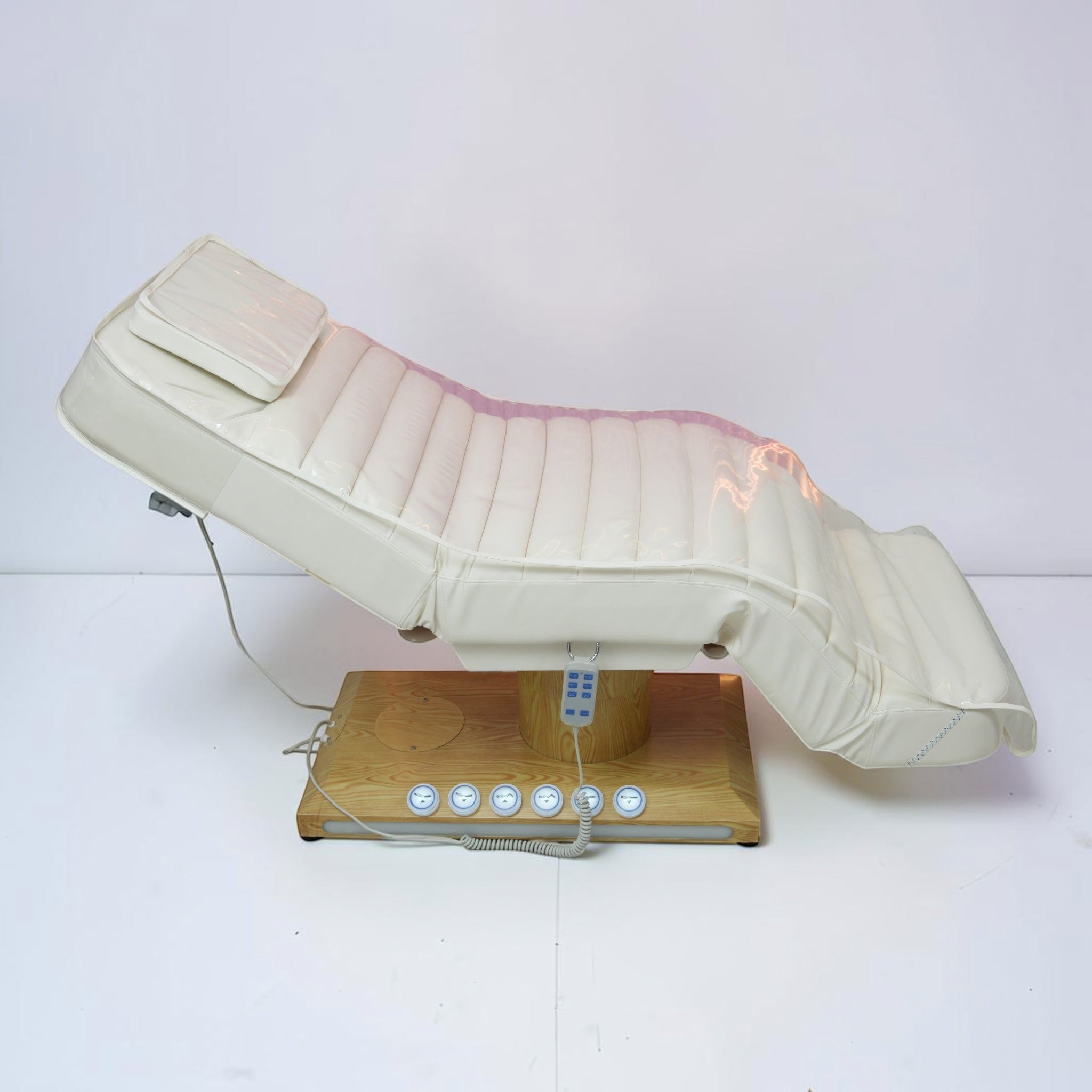 MK BEAUTY BED luxury electric treatment bed in white PU leather with a wooden base and handheld remote control.